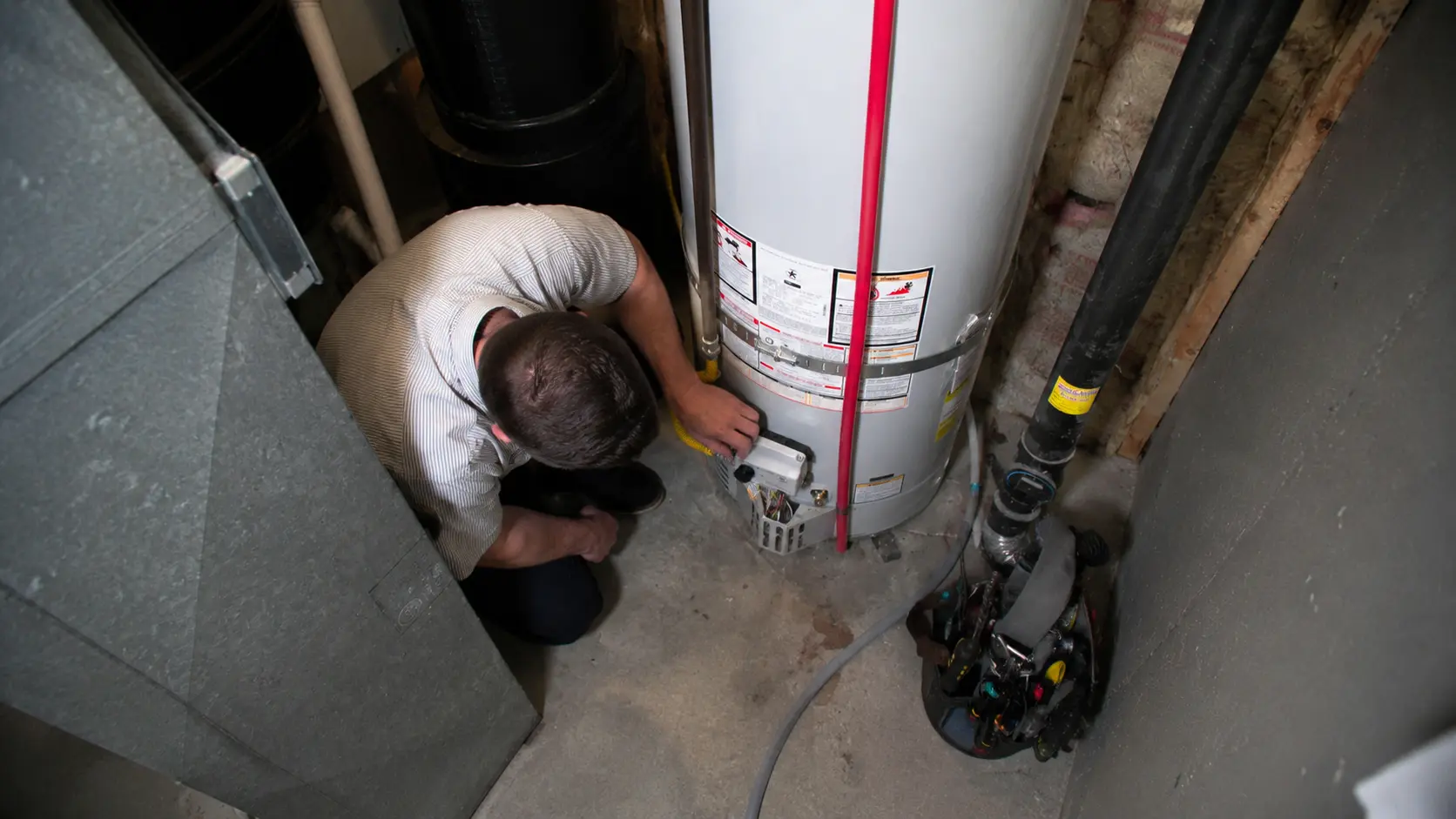 overhead-plumber-servicing-gas-water-heater-donahue-plumbing